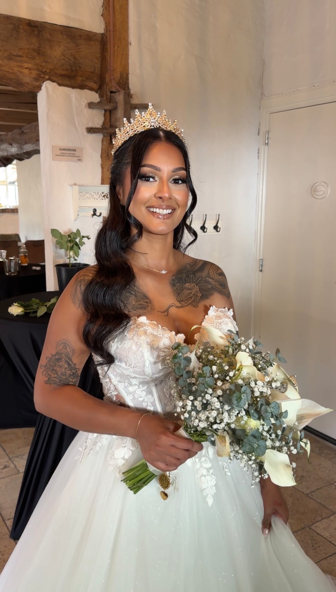 Bride holding a bouquet with finished makeup and hair