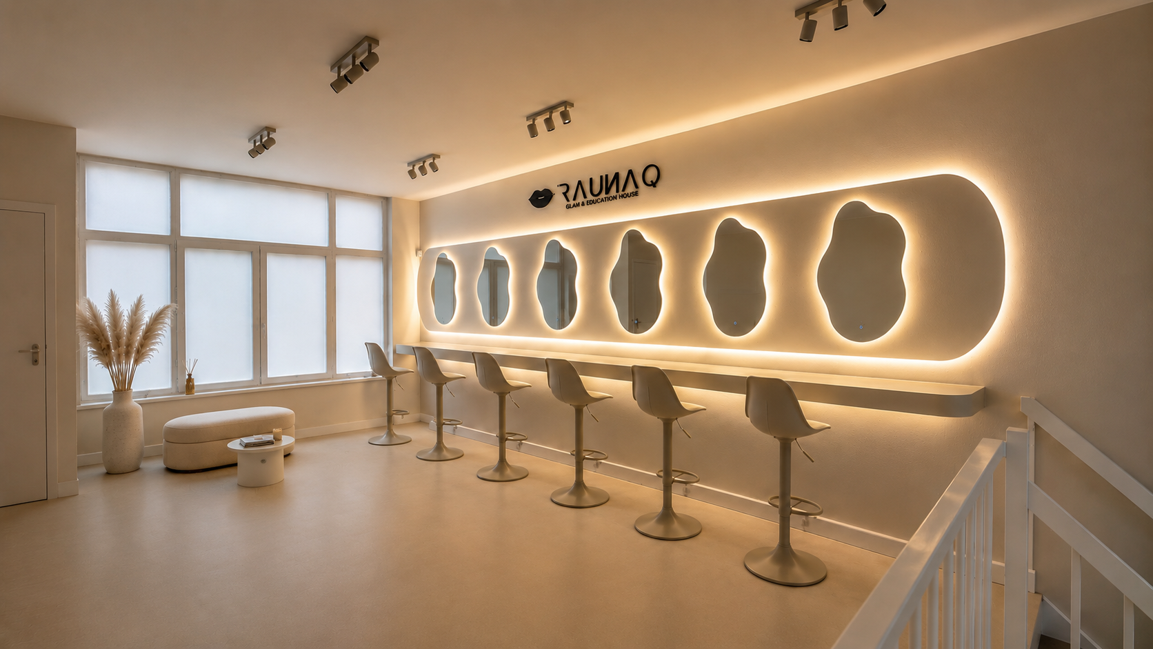 RAUNAQ studio interior — illuminated makeup bar and mirrors