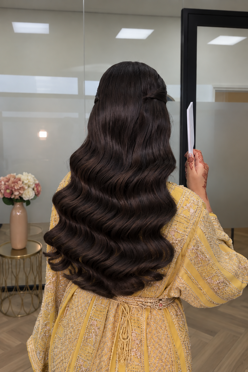Long voluminous waves with gold occasion outfit at RAUNAQ